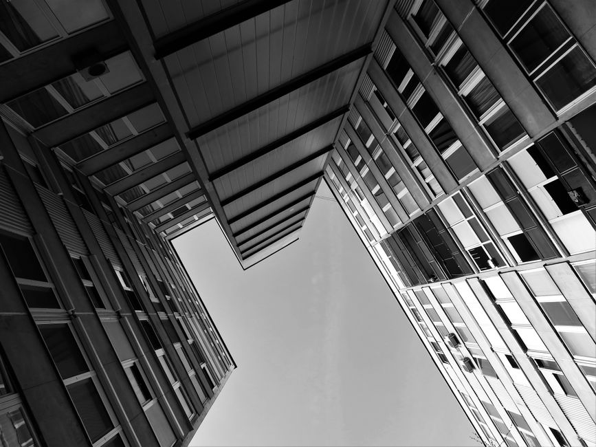 Black and white photo of futuristic skyscrapers with a dynamic perspective.