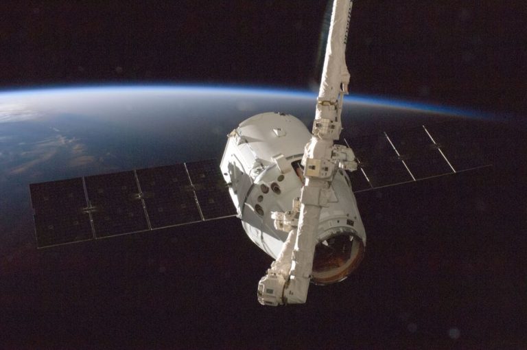 A satellite orbiting Earth with a view of the planet from space.
