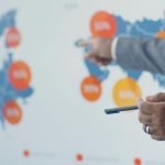 Professional presenting detailed analytics on European map during office meeting.