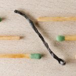 How to Overcome Organizational Immunity and Drive Change Charred match surrounded by green-tipped matches symbolizing burnout and contrast.