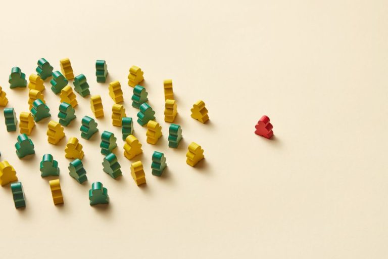 Arrangement of colorful game pieces on a light yellow background creates a striking contrast.