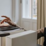 How to Reduce Organizational Friction Through AI Automation A stylish woman organizes documents in a modern office setting.