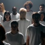 Individual Sovereignty and Modern Leadership Strategy | 2026 A diverse group of individuals in white shirts standing in a studio setting.