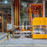 Detailed view of machinery in an operational glass factory in Dar es Salaam.