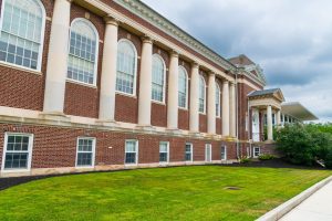 A historic brick building with columns in Gettysburg on a cloudy day.