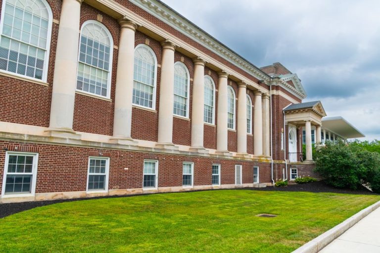 A historic brick building with columns in Gettysburg on a cloudy day.