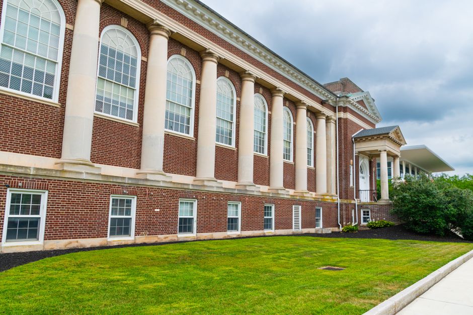 A historic brick building with columns in Gettysburg on a cloudy day.