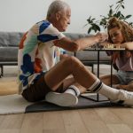 Intergenerational Justice: A Strategic Imperative for Leaders Elderly man and young girl deeply focused on a chess game in a cozy living room setting.