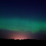 A mesmerizing display of the Aurora Borealis in the night sky over Ventspils, Latvia.