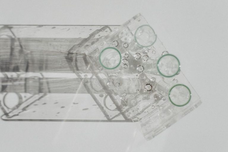 Laboratory glassware setup viewed from above on a white background, featuring various flasks.