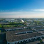 Local Manufacturing Hubs: A Strategic Guide for Resilience Expansive aerial view of an industrial area showcasing buildings, roads, and green spaces.