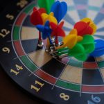 A close-up shot of colorful magnetic darts clustered on a dartboard, showcasing precision.