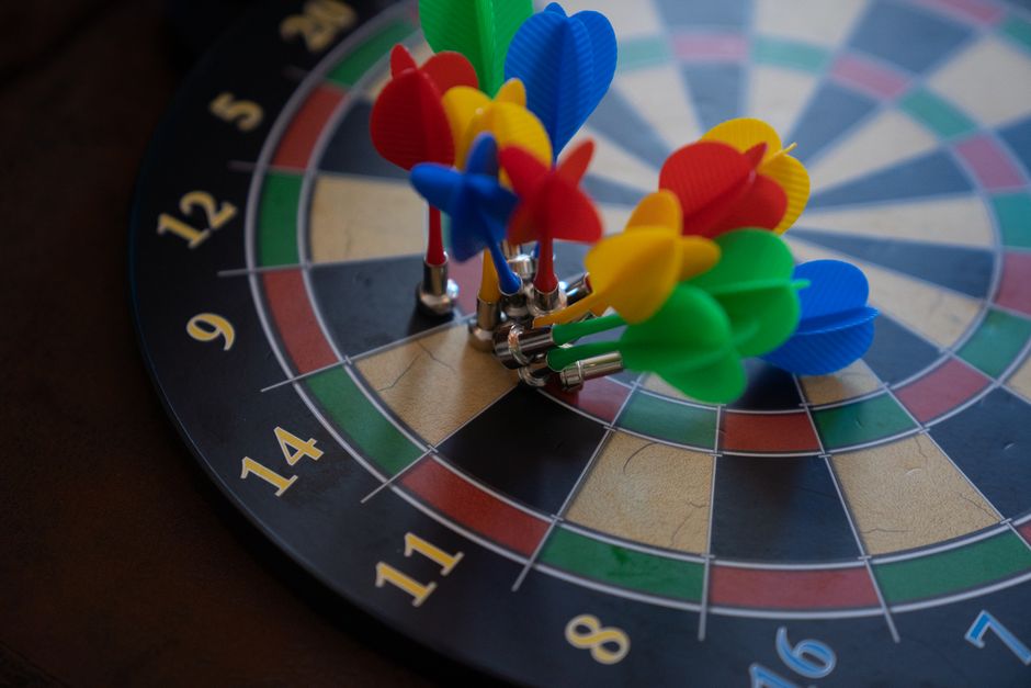 A close-up shot of colorful magnetic darts clustered on a dartboard, showcasing precision.