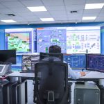 Managing Transnational Operations at Scale: Strategy & Law Operator in a modern control room managing technological systems in El Agustino, Lima.