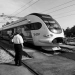 Master Multi-Modal Transport Networks for Supply Chain Resilience A modern train at a railway station, capturing the essence of transportation in black and white.