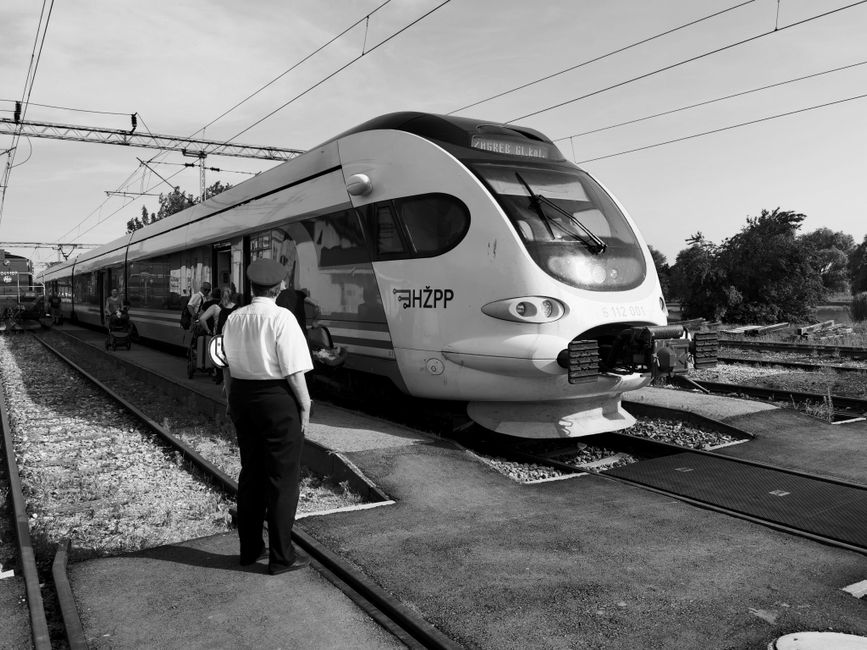 A modern train at a railway station, capturing the essence of transportation in black and white.