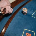 Mastering High-Stakes Public-Private Partnership Execution Detailed view of a casino gaming table with poker chips and a wooden pipe on the side.