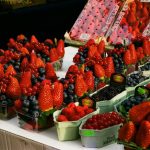 Delicious assortment of fresh berries including strawberries and blueberries at a market in Prague.