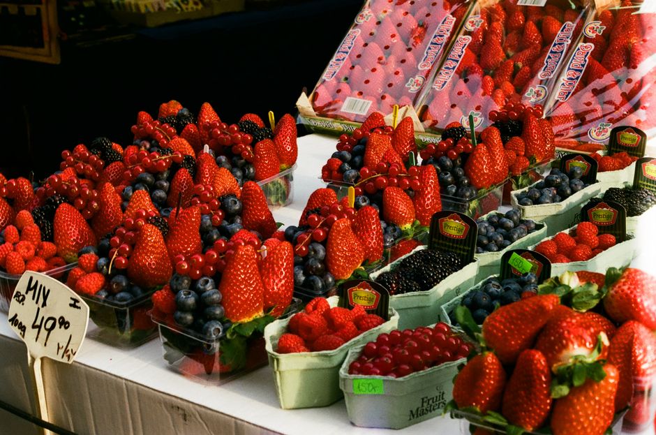 Delicious assortment of fresh berries including strawberries and blueberries at a market in Prague.