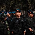 Indonesian police and military personnel in uniform during an operation in Bangkalan, East Java.