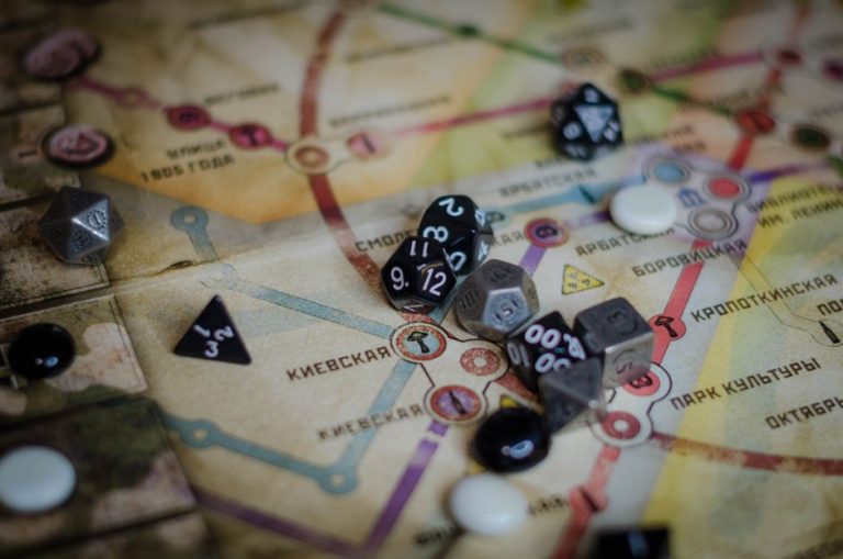 A vibrant board game scene featuring dice and a colorful map layout.