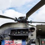 Military-Industrial Complex: Lessons in Strategy and Scale Detailed view of a military helicopter rotor and open mechanism, showing complex engineering.