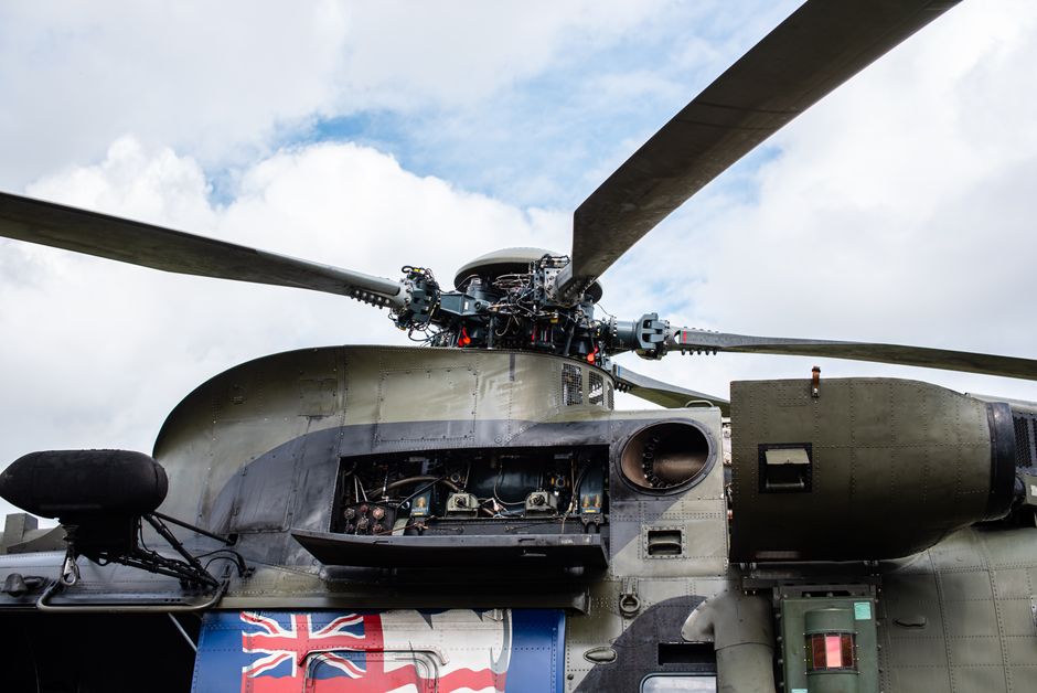 Detailed view of a military helicopter rotor and open mechanism, showing complex engineering.