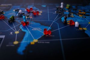A strategic board game featuring a world map and colorful playing pieces.