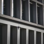 Neuro-rights and Corporate Privacy: Protecting Cognitive Liberty Contemporary office building exterior featuring multiple windows and security cameras.
