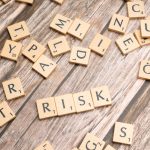Operational Risk of Esoteric Technology: A Strategic Guide Scrabble tiles spelling out 'risk' scattered on a rustic wooden background, symbolizing uncertainty.