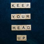 Optimize Your Cognitive Performance with Cerebral Cloud-Sync Inspirational message 'Keep Your Head Up' in Scrabble tiles on a dark blue background.