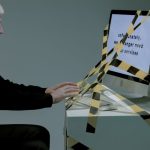 Overcoming Technological Unemployment: A Strategic Framework Elderly man at computer with termination notice, facing unemployment.