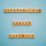 Personalized Medicine Strategy: Why Precision is the Future Conceptual image with Scrabble tiles on a blue background spelling 'Personalized Cancer Therapy'.