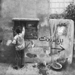 A candid urban street scene in Tehran, capturing daily life in monochrome.
