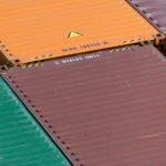 Predictive Logistics: Strategic Advantage in Supply Chain Ops Aerial view of vibrant cargo containers arranged in a pattern, emphasizing logistics and transportation.