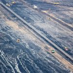 Aerial perspective of an expansive open-pit mine in Inden, Germany showcasing industrial mining operations.