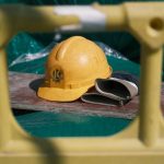 Safety Standards as a Competitive Moat in Space Tourism Close-up of a yellow construction helmet on a workbench at a building site.