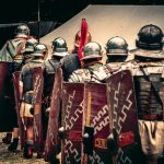 Reenactors in Roman legion outfits march in a historical festival in Wrocław, Poland.