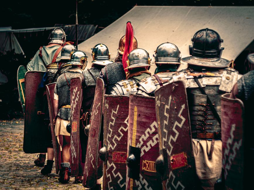 Reenactors in Roman legion outfits march in a historical festival in Wrocław, Poland.