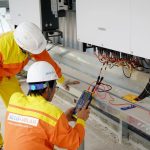 Solar Geo-engineering: Strategic Risks in Climate Management Two electrical engineers installing and testing solar power systems wearing safety gear at a construction site.