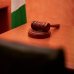 Space Governance and Jurisdictional Challenges in Space Economy A close-up of a gavel on a courtroom desk representing law and justice.