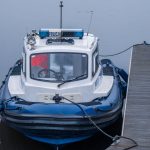 A Polish police boat docked, showcasing nautical safety and security.