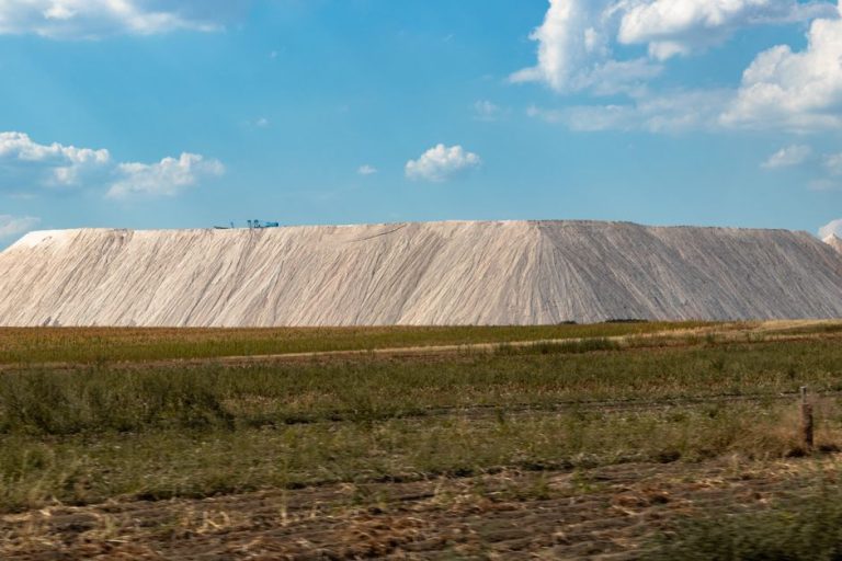 Expansive salt mine landscape with clear blue sky, capturing natural industry outdoors.