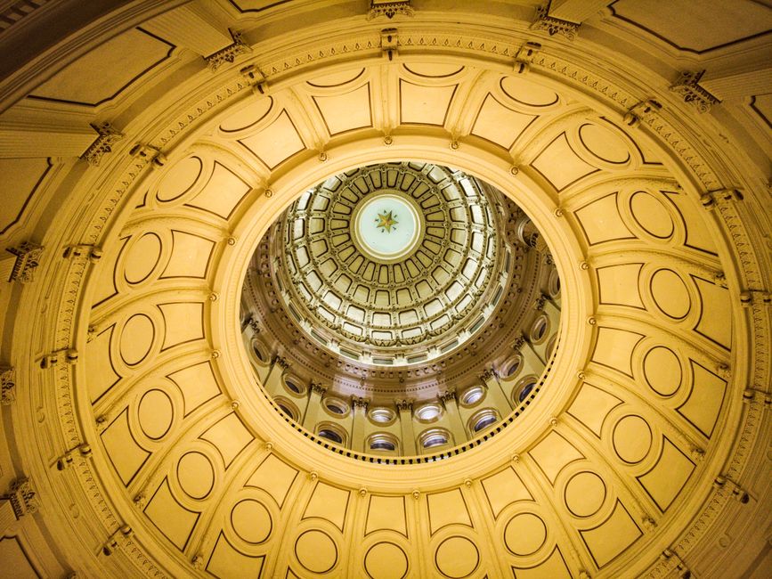 A stunning look up at the Texas Capitol dome in Austin, showcasing its intricate design and geometry.