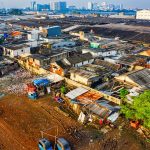 Structural Inequality: A Strategy for Organizational Resilience Aerial shot depicting urban slums in Jakarta with visible pollution and crowded housing.