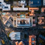 Sub-surface Urban Development: The New Strategic Imperative Stunning aerial shot of Sandton's urban landscape showcasing modern architecture, roads, and rooftop pools.