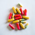 Synthetic Food Production: A Strategic Imperative for 2026 A vibrant assortment of various pills and capsules on a light background, showcasing pharmaceutical diversity.