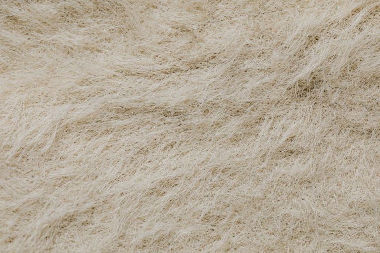 High-resolution close-up of a textured surface with beige natural fibers forming intricate patterns.