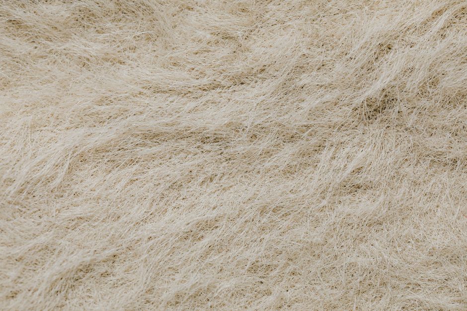 High-resolution close-up of a textured surface with beige natural fibers forming intricate patterns.