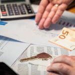 TaaS: Why Asset Ownership is No Longer a Strategic Moat Hands examining financial documents, a 50 euro note, and a key, suggesting investment or real estate themes.